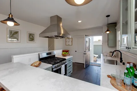 a kitchen with a sink a counter and cabinets