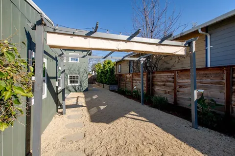 a view of a porch with furniture and next to a yard