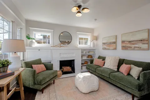 a living room with furniture and a fireplace