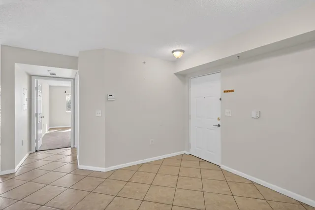 a view of a kitchen with white cabinets