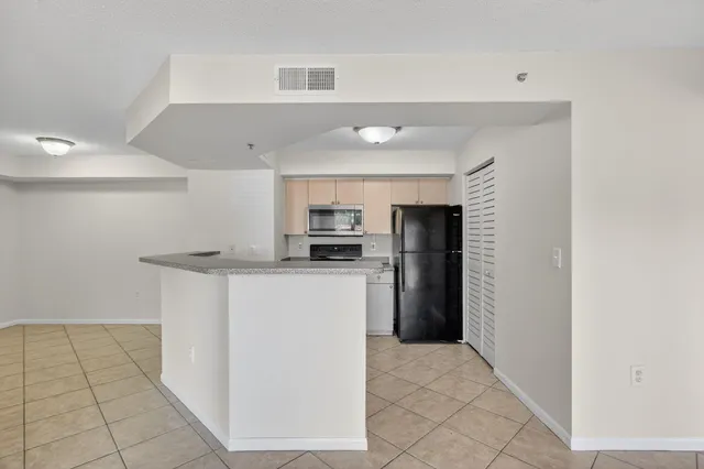 a kitchen with a sink stainless steel appliances and cabinets