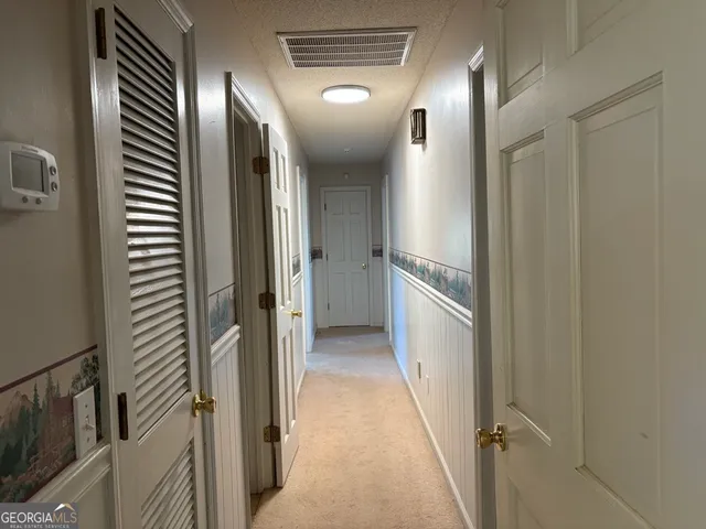 a view of a hallway with wooden floor