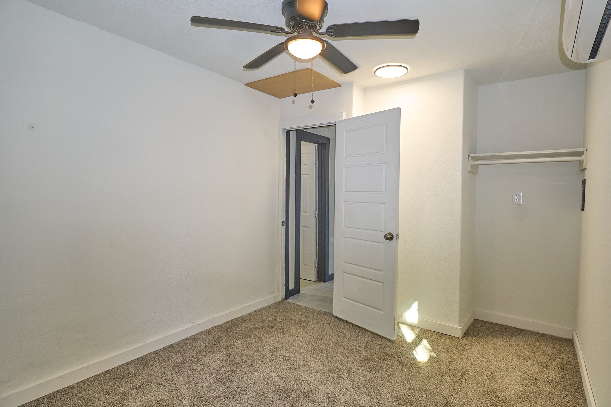 9010 Linda Vista Road Houston, TX 77078 - Photo 12 of 24 an empty room with closet and a chandelier fan
