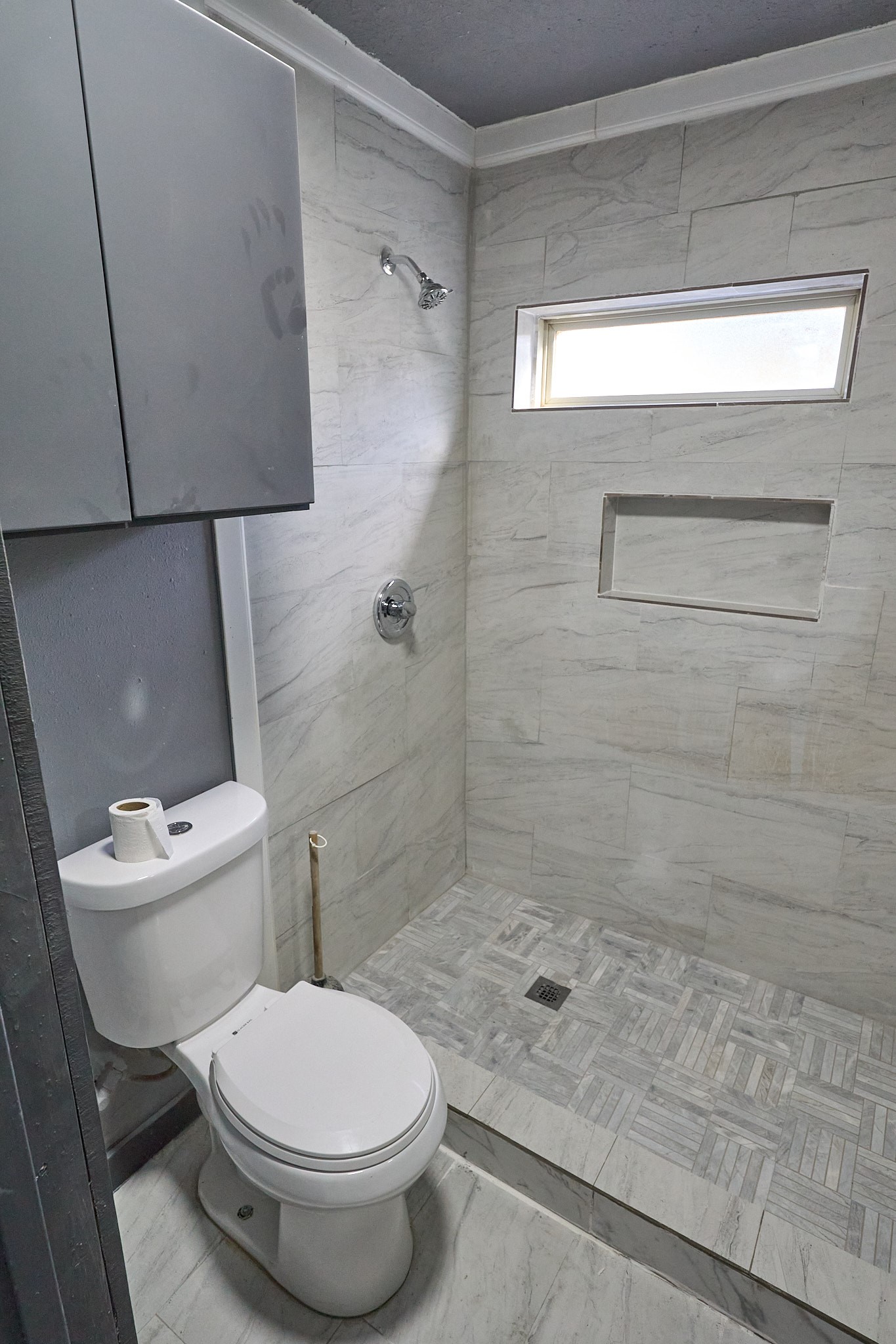9010 Linda Vista Road Houston, TX 77078 - Photo 13 of 24 a white toilet sitting next to a shower