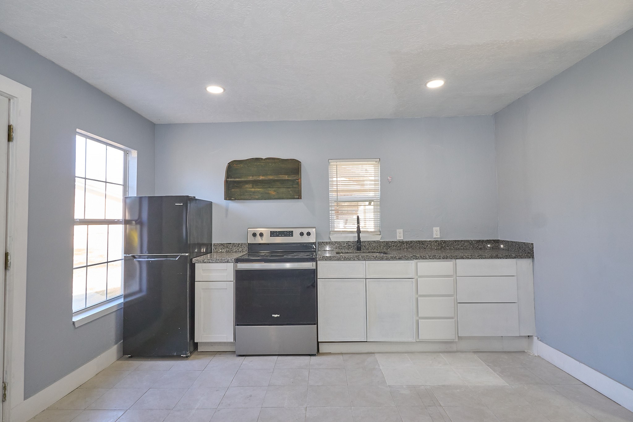 9010 Linda Vista Road Houston, TX 77078 - Photo 18 of 24 a kitchen with stainless steel appliances granite countertop a stove a sink and a refrigerator