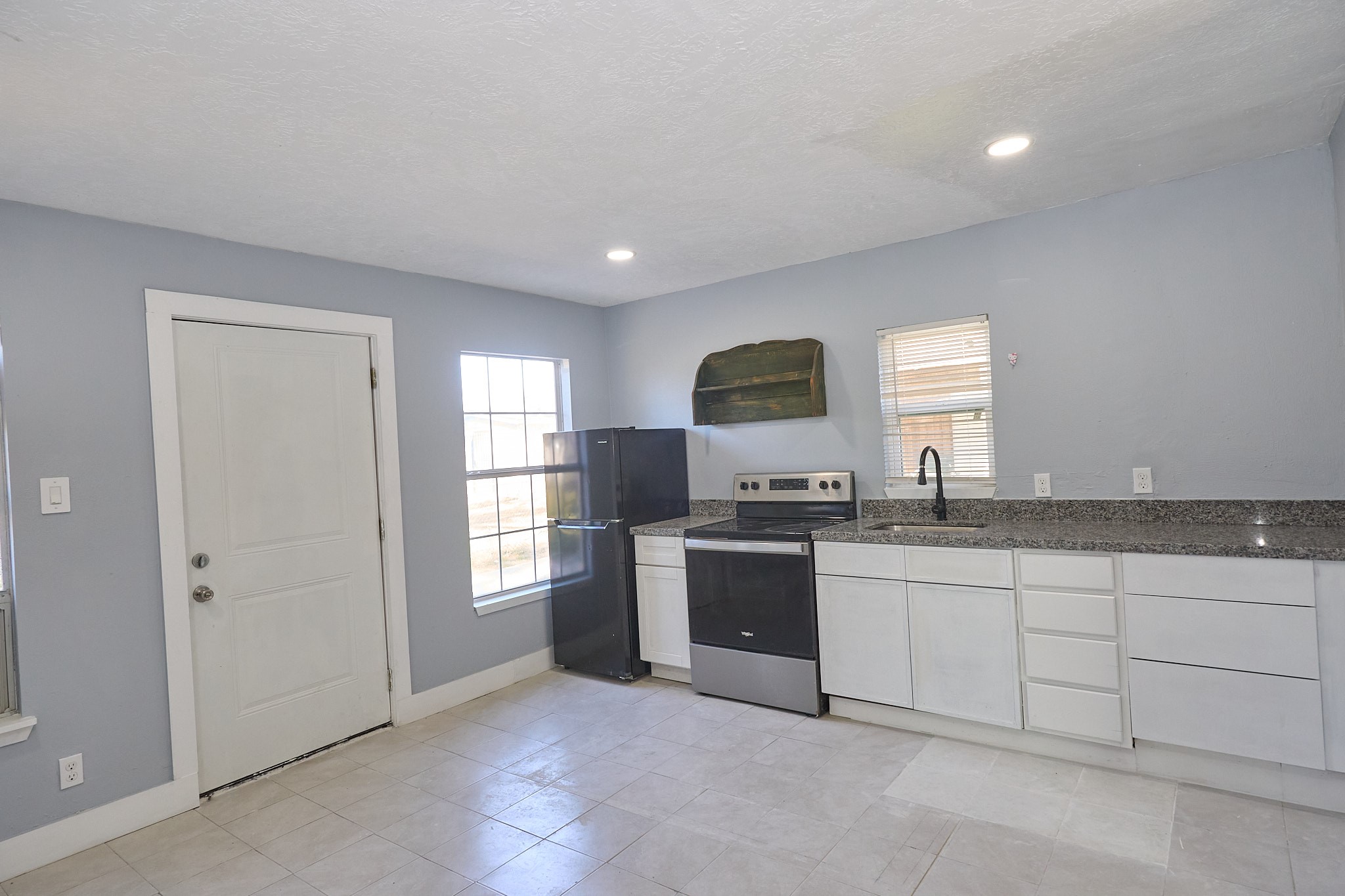 9010 Linda Vista Road Houston, TX 77078 - Photo 19 of 24 a kitchen with granite countertop a sink and cabinets