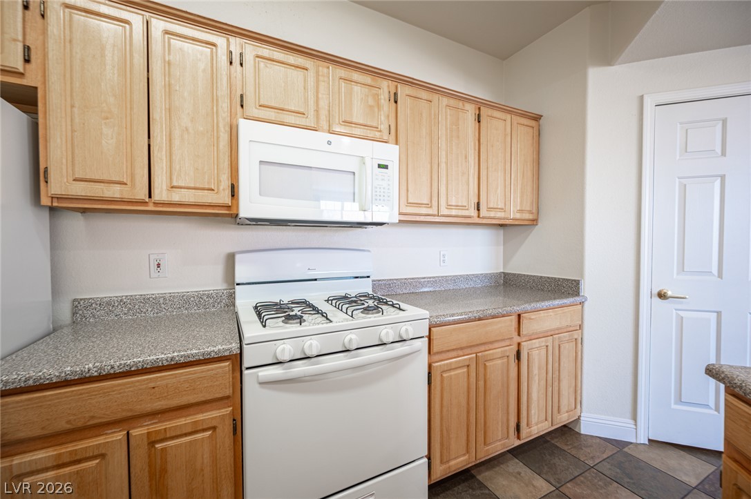 8555 West Russell Road, Unit 2062 Las Vegas, NV 89113 - Photo 16 of 35 A well-appointed kitchen features ample light wood cabinetry and functional appliances.