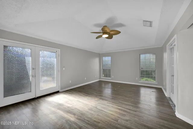 a view of a patio with table and chairs potted plants