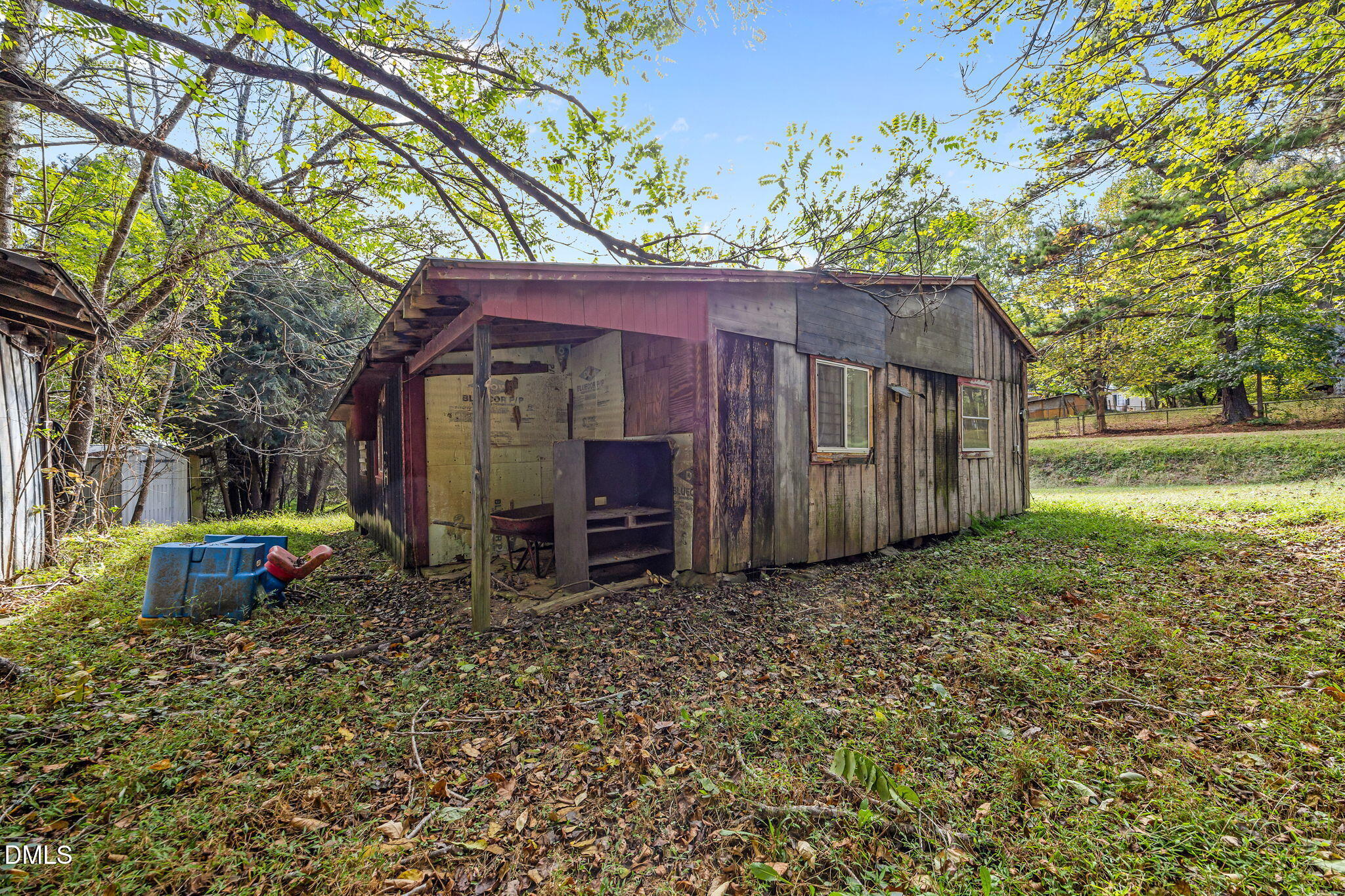 3801 Buckhorn Road Efland, NC 27243 - Photo 25 of 25 a view of a small house with a large tree and a yard