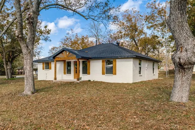 a house that has a tree in front of it