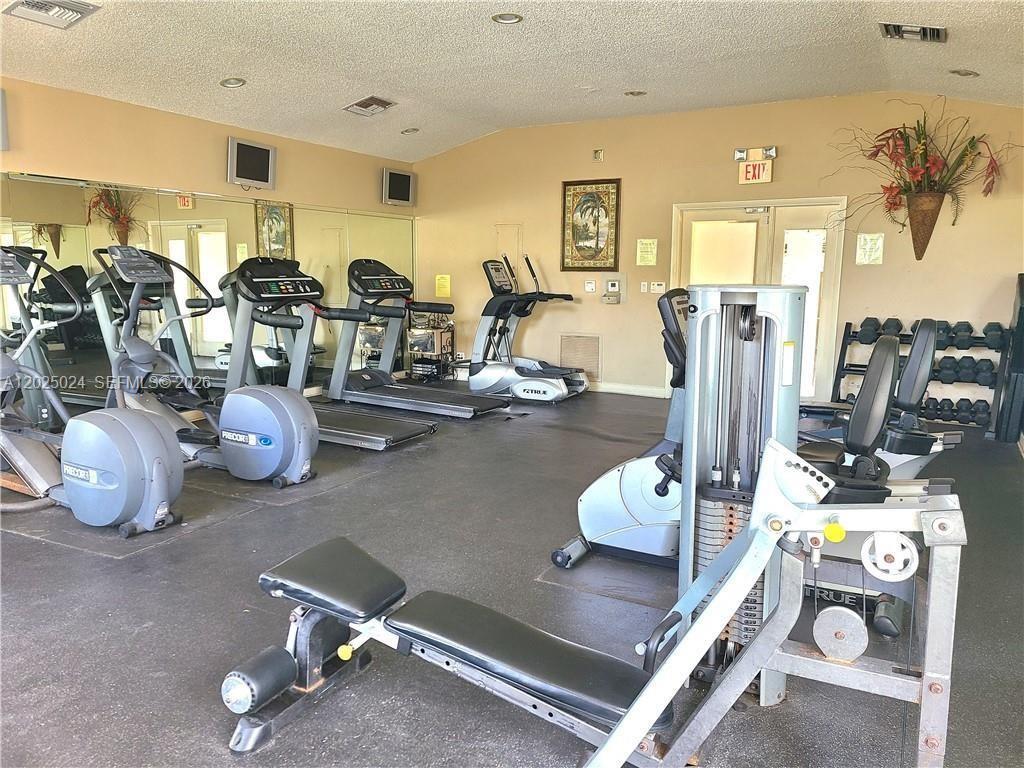 631 Lyons Road, Unit 12205 Coconut Creek, FL 33063 - Photo 13 of 14 a room with gym equipment