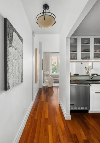 a kitchen with kitchen island granite countertop wooden floors and wide window