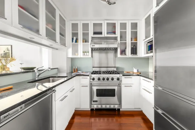 a white kitchen with a stove top oven