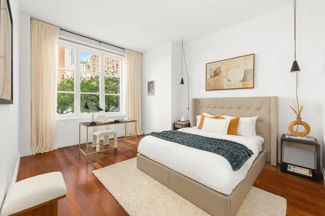 a bed room with a bed and a chair