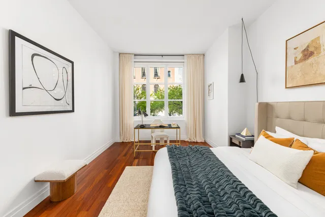 a bedroom with bed and a window