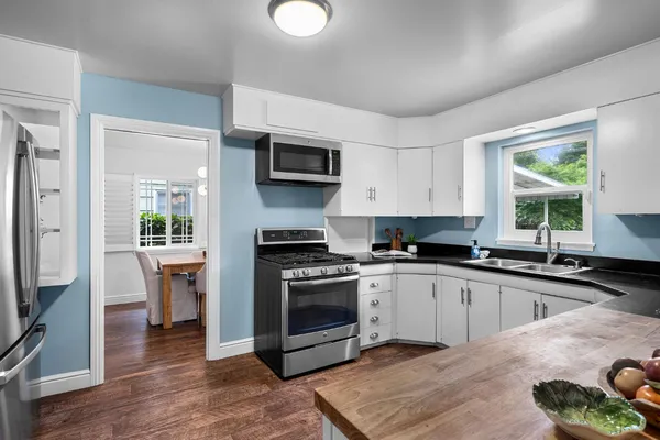 a kitchen with a sink stove and refrigerator