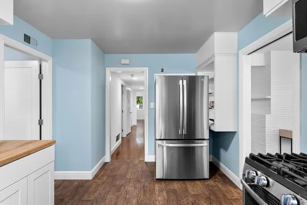 a kitchen with stainless steel appliances a refrigerator and a stove