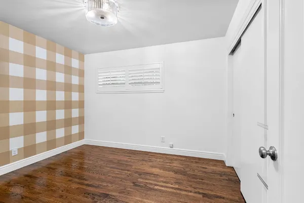 a view of a room with wooden floor and fan
