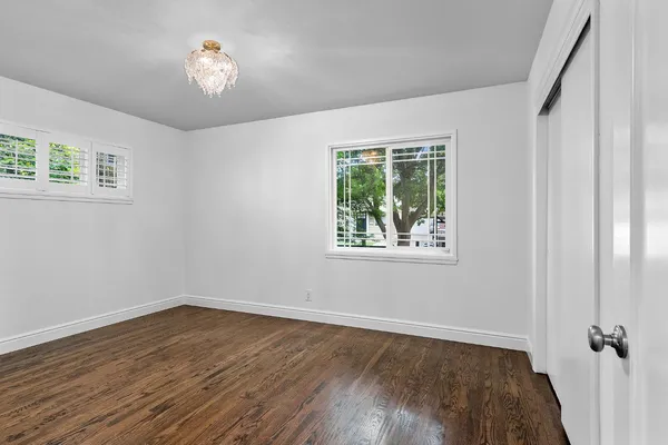 a view of a room with wooden floor and window