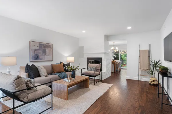 a living room with furniture potted plant and a fireplace