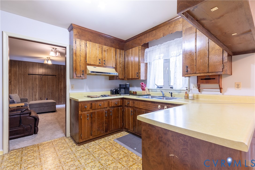 3317 Hastings Road Petersburg, VA 23805 - Photo 7 of 25 a kitchen with stainless steel appliances wooden cabinets a sink and a stove