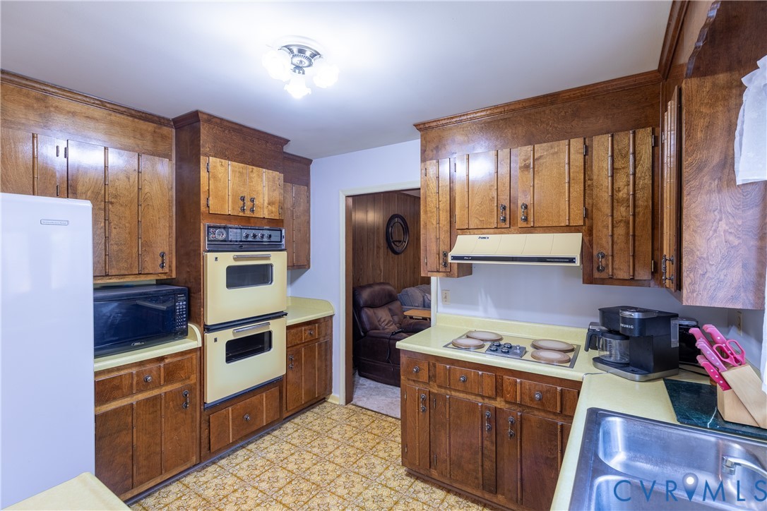 3317 Hastings Road Petersburg, VA 23805 - Photo 8 of 25 a kitchen with stainless steel appliances granite countertop a stove a sink and a refrigerator