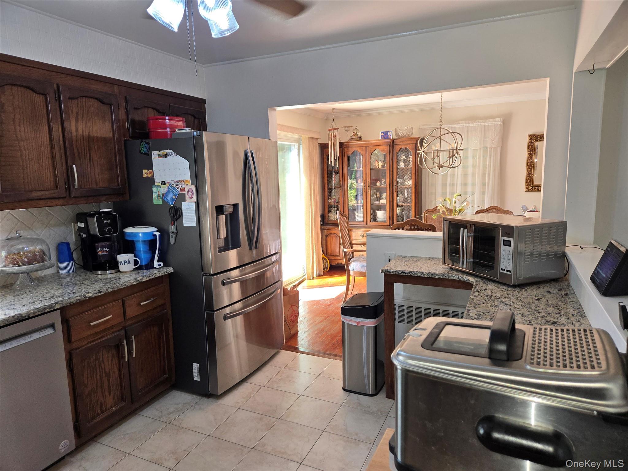 810 Fenimore Road Mamaroneck, NY 10543 - Photo 11 of 33 a kitchen with stainless steel appliances granite countertop a refrigerator and a stove