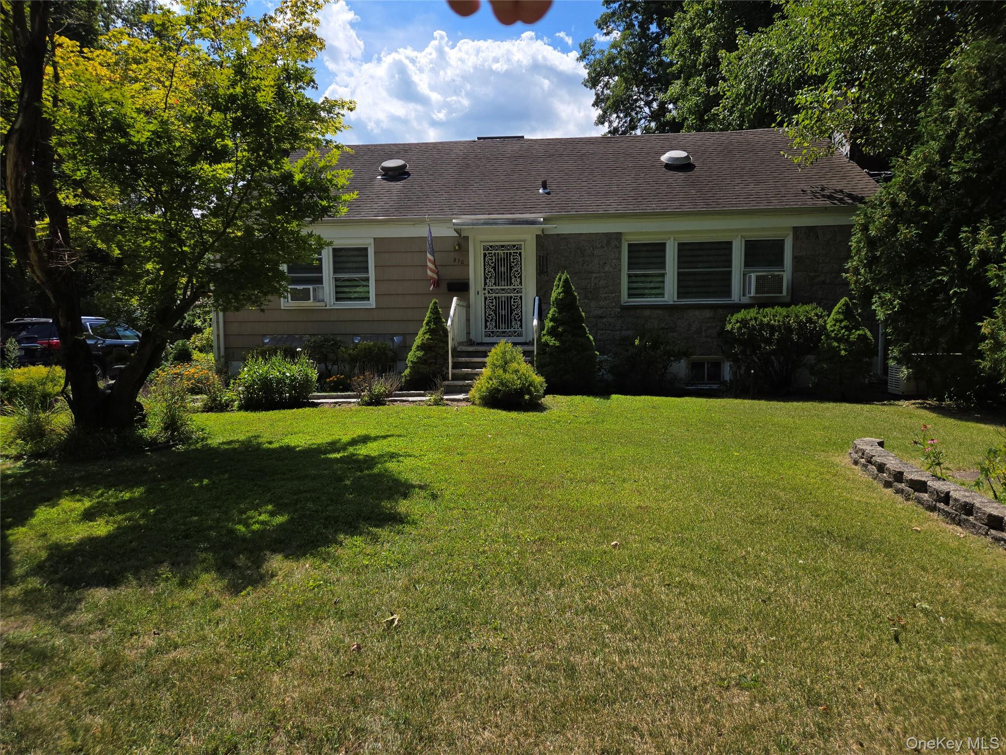 810 Fenimore Road Mamaroneck, NY 10543 - Photo 2 of 33 a front view of a house with yard and green space