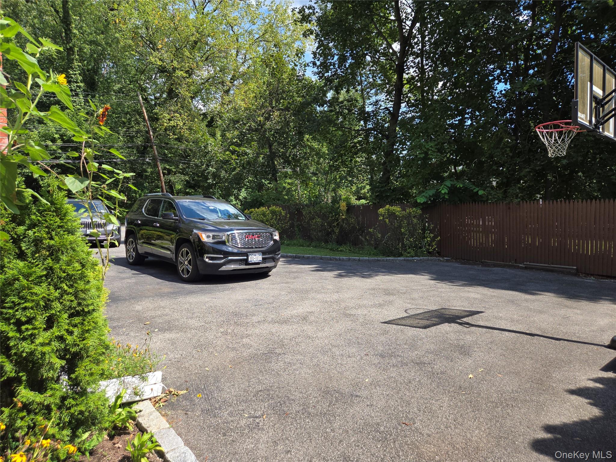 810 Fenimore Road Mamaroneck, NY 10543 - Photo 31 of 33 a car parked in front of a white house