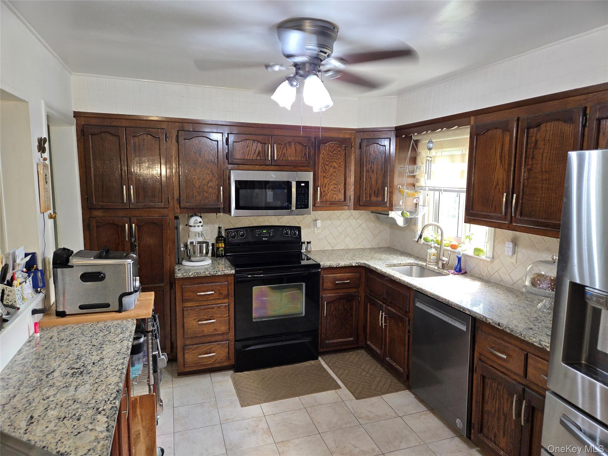 810 Fenimore Road Mamaroneck, NY 10543 - Photo 9 of 33 a kitchen with stainless steel appliances granite countertop a sink stove and oven