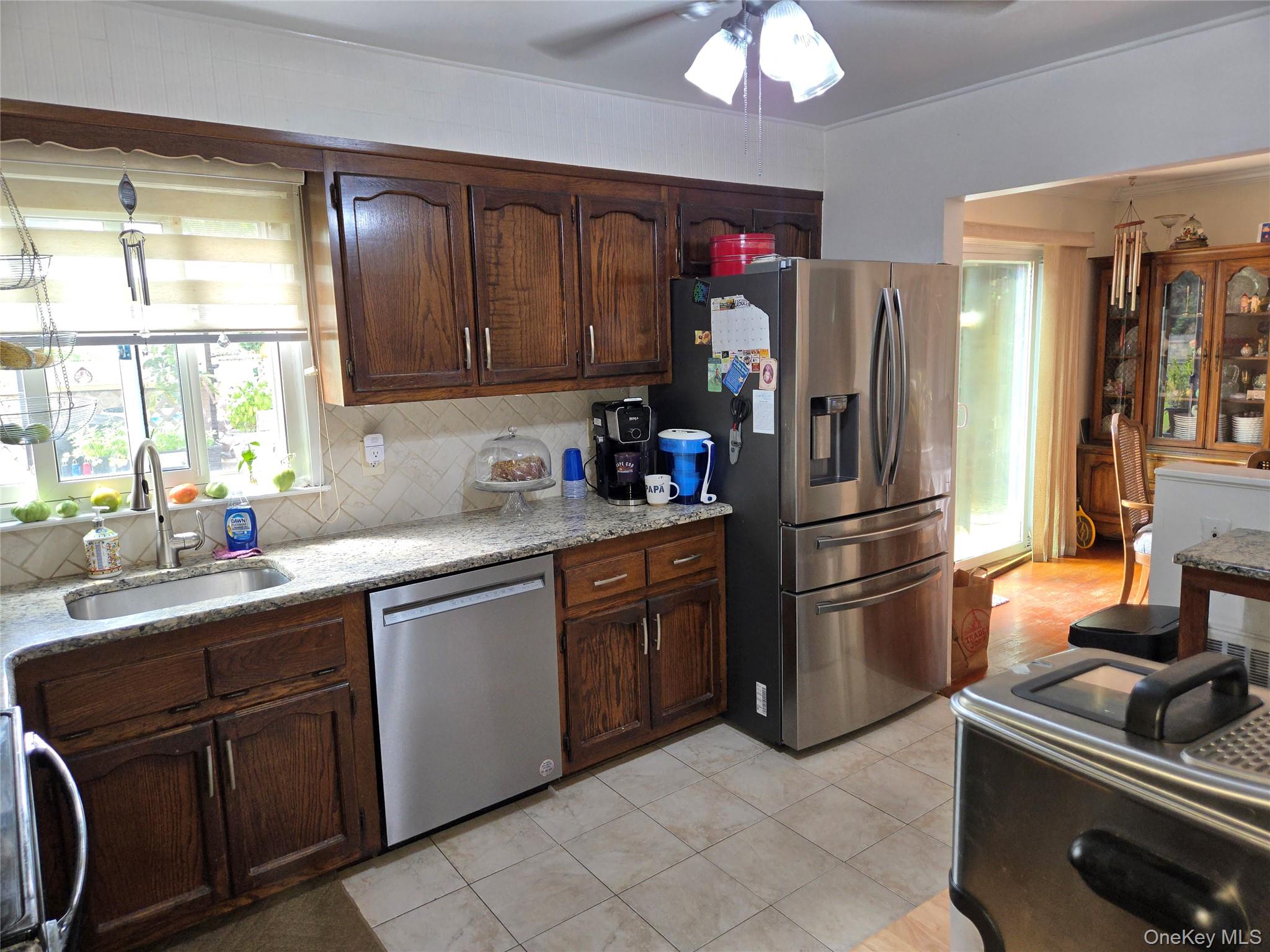 810 Fenimore Road Mamaroneck, NY 10543 - Photo 10 of 33 a kitchen with a refrigerator and a sink