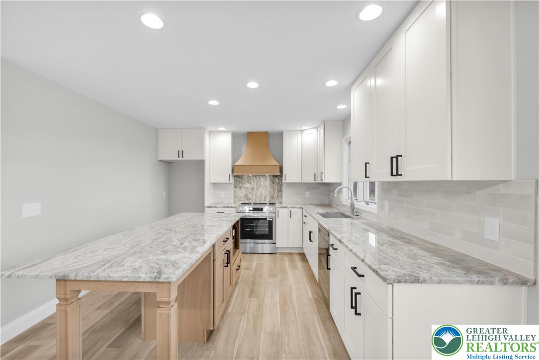 670 Cider Press Road Easton, PA 18042 - Photo 13 of 48 a large kitchen with granite countertop a large counter top a sink stainless steel appliances and cabinets