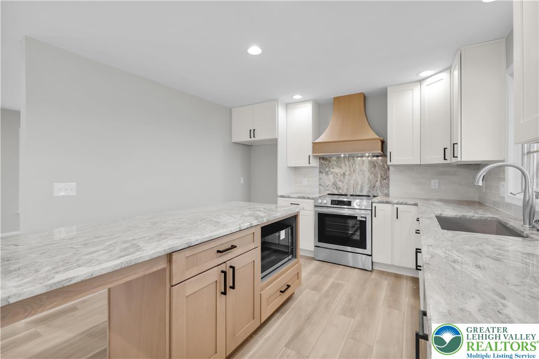 670 Cider Press Road Easton, PA 18042 - Photo 14 of 48 a kitchen with granite countertop white cabinets and white appliances