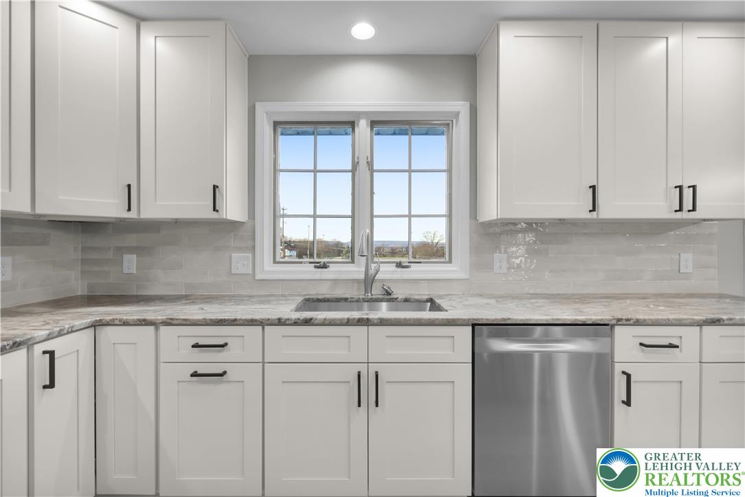 670 Cider Press Road Easton, PA 18042 - Photo 17 of 48 a kitchen with granite countertop white cabinets and a sink