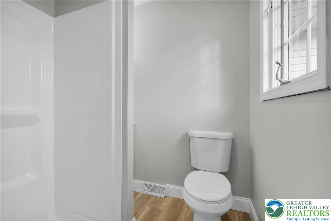 670 Cider Press Road Easton, PA 18042 - Photo 28 of 48 a white toilet sitting in a bathroom next to a window