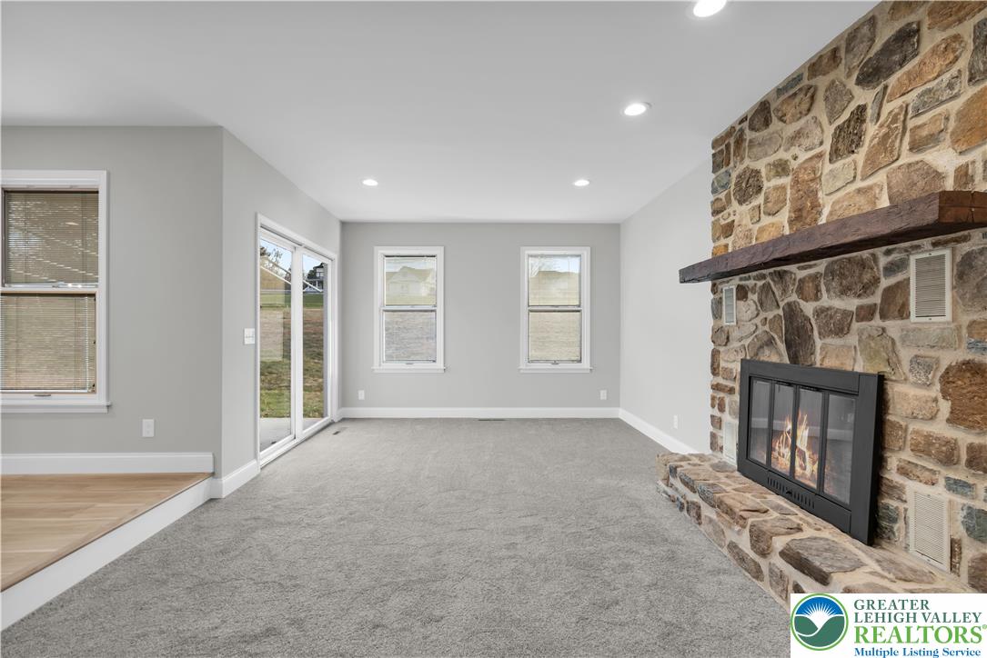 670 Cider Press Road Easton, PA 18042 - Photo 5 of 48 a view of an empty room with a fireplace and a window
