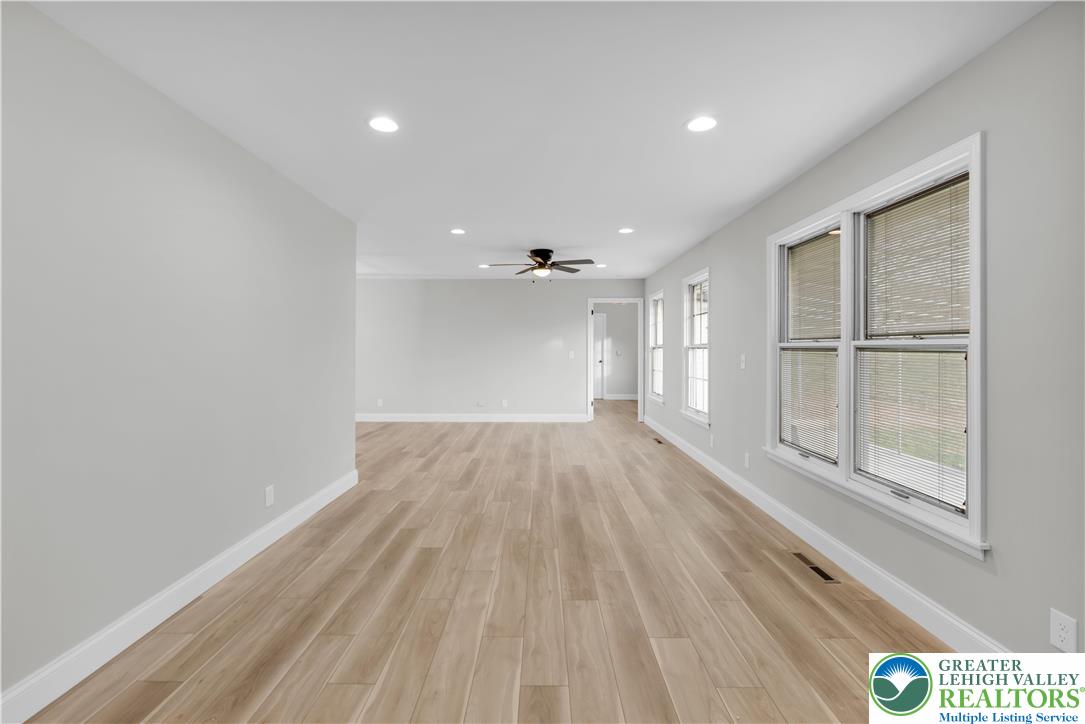 670 Cider Press Road Easton, PA 18042 - Photo 9 of 48 a view of empty room with wooden floor and fan