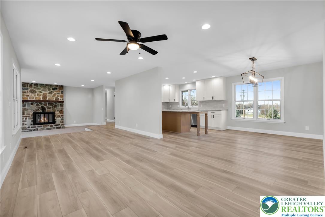 670 Cider Press Road Easton, PA 18042 - Photo 10 of 48 a view of an empty room and kitchen view with wooden floor