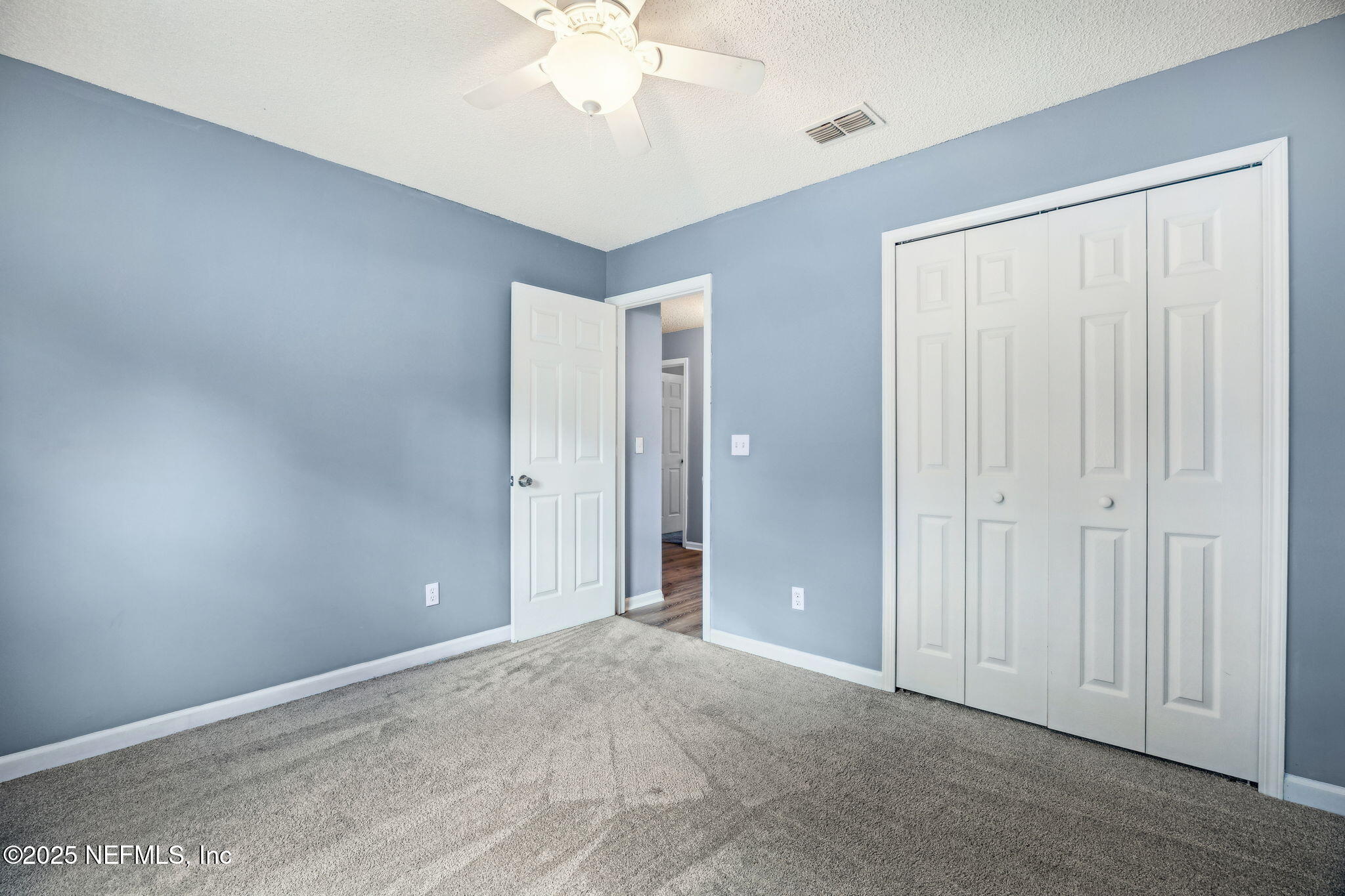 86001 Grant Place Yulee, FL 32097 - Photo 18 of 26 an empty room with a chandelier fan