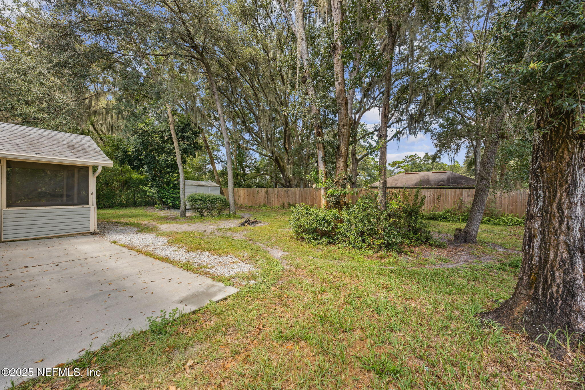 86001 Grant Place Yulee, FL 32097 - Photo 23 of 26 a view of a backyard with large trees
