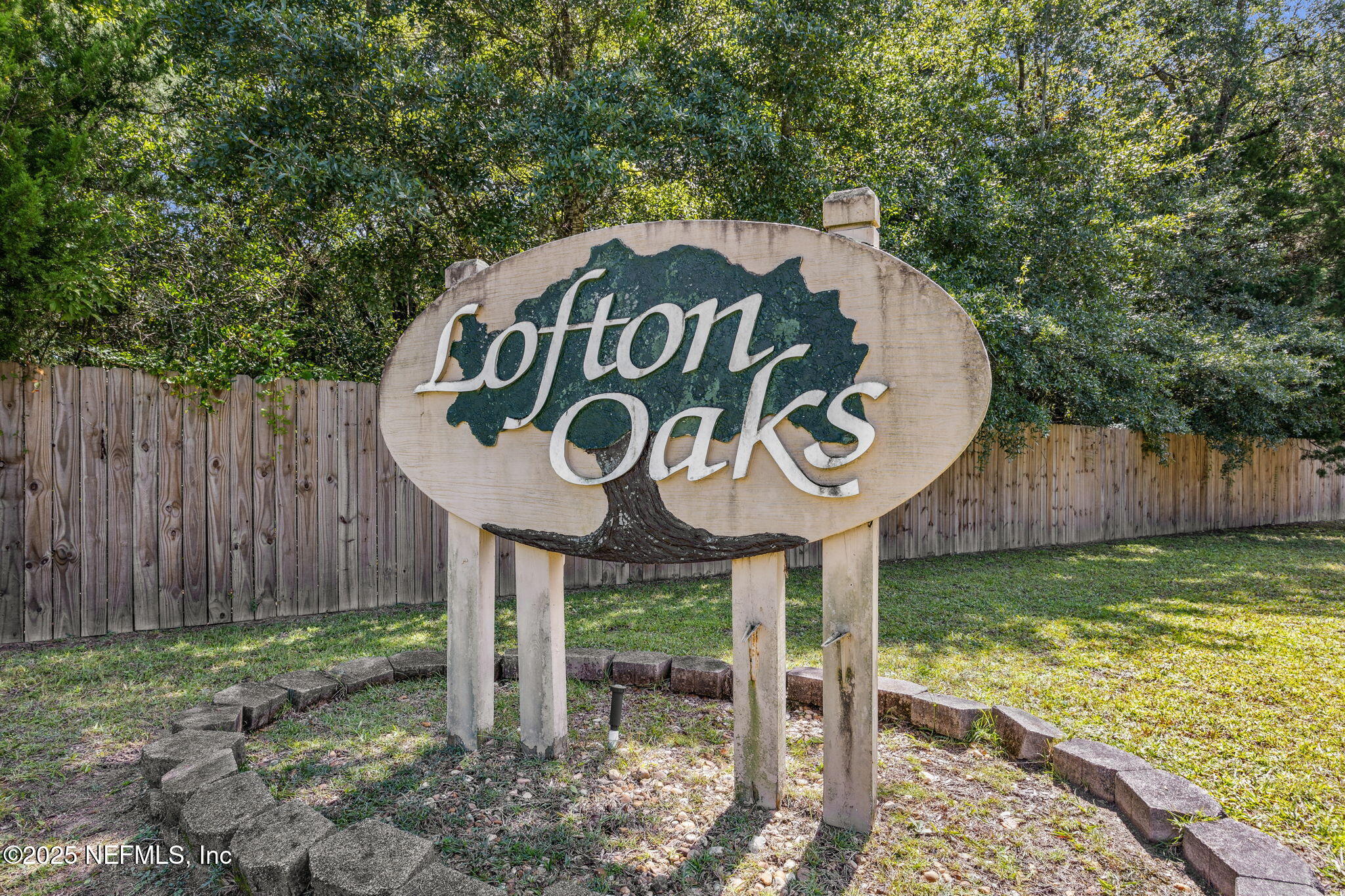 86001 Grant Place Yulee, FL 32097 - Photo 26 of 26 a view of a wooden fence under a large tree