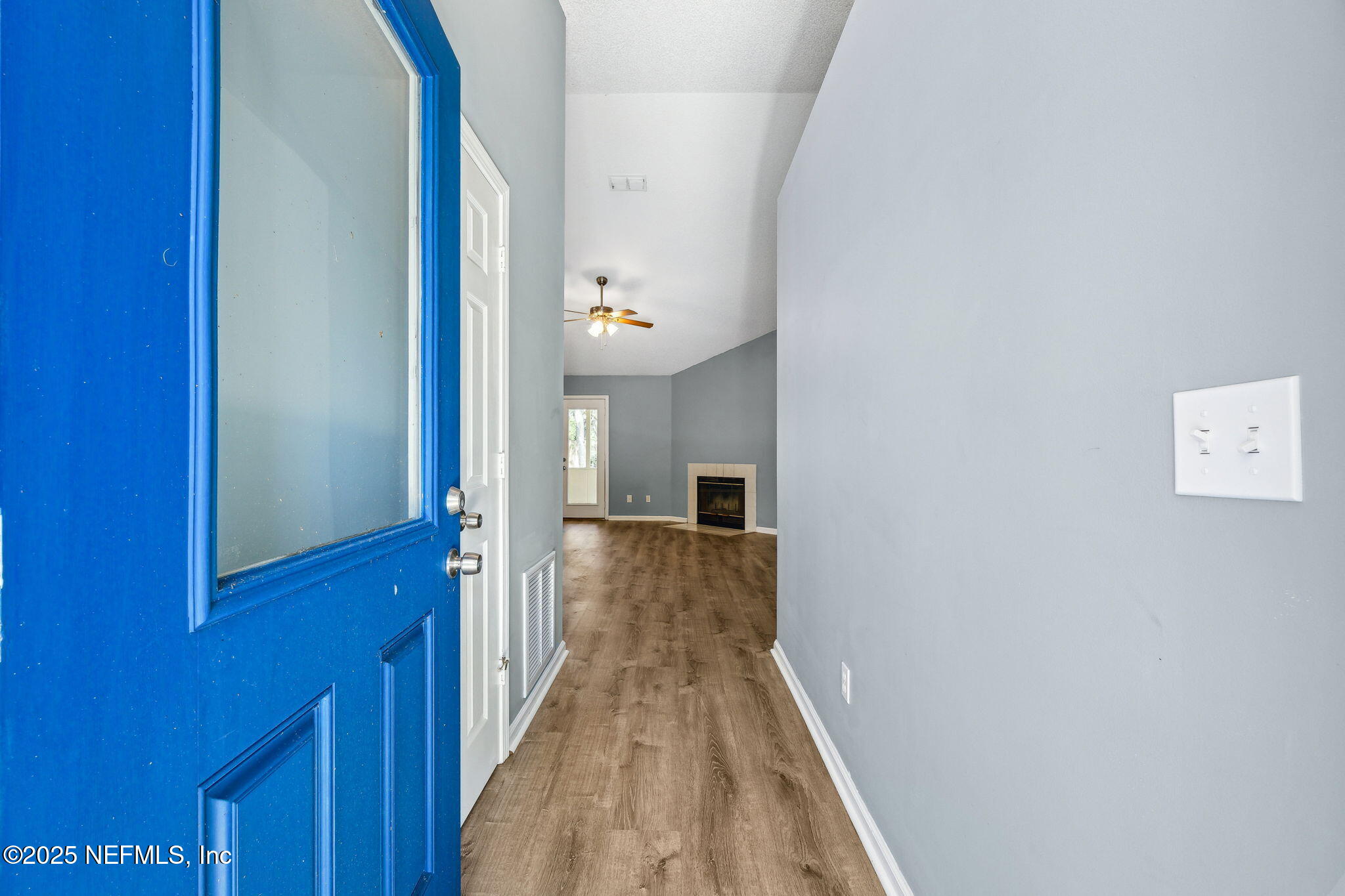 86001 Grant Place Yulee, FL 32097 - Photo 3 of 26 a view of a hallway with wooden floor and staircase