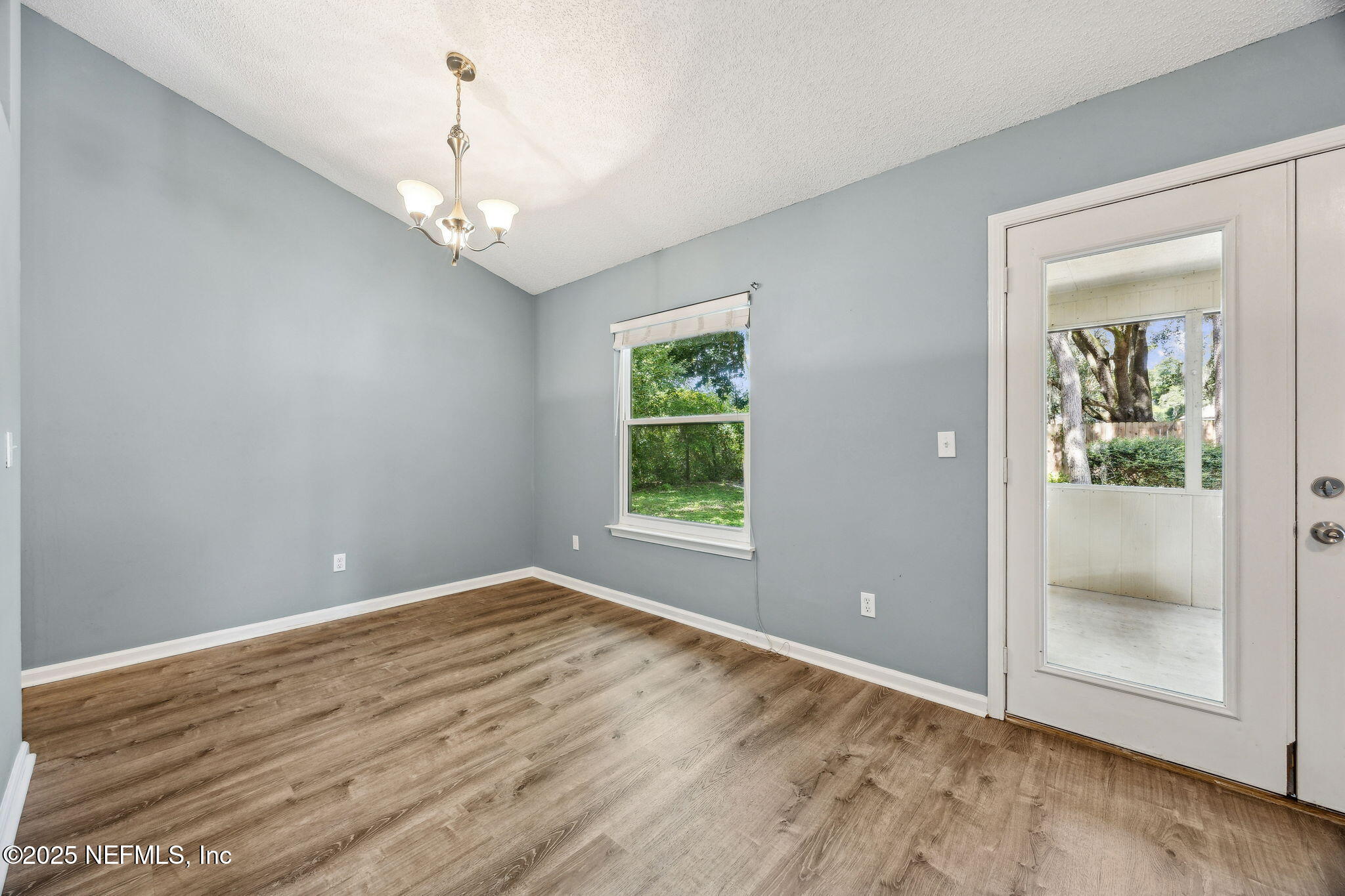 86001 Grant Place Yulee, FL 32097 - Photo 6 of 26 wooden floor in an empty room with a window