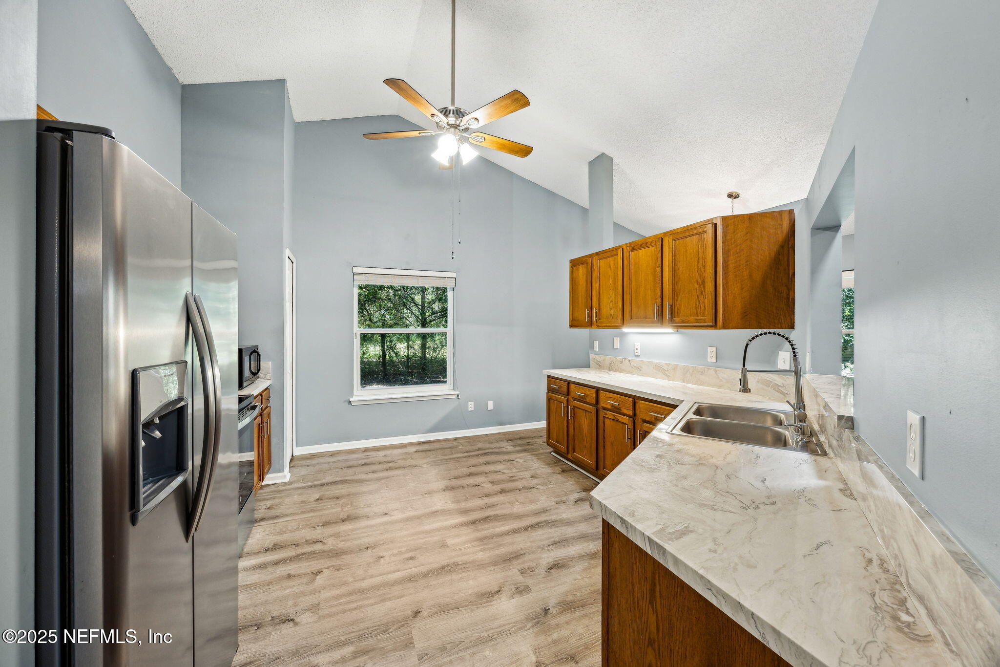 86001 Grant Place Yulee, FL 32097 - Photo 8 of 26 a kitchen with stainless steel appliances granite countertop a sink refrigerator and microwave