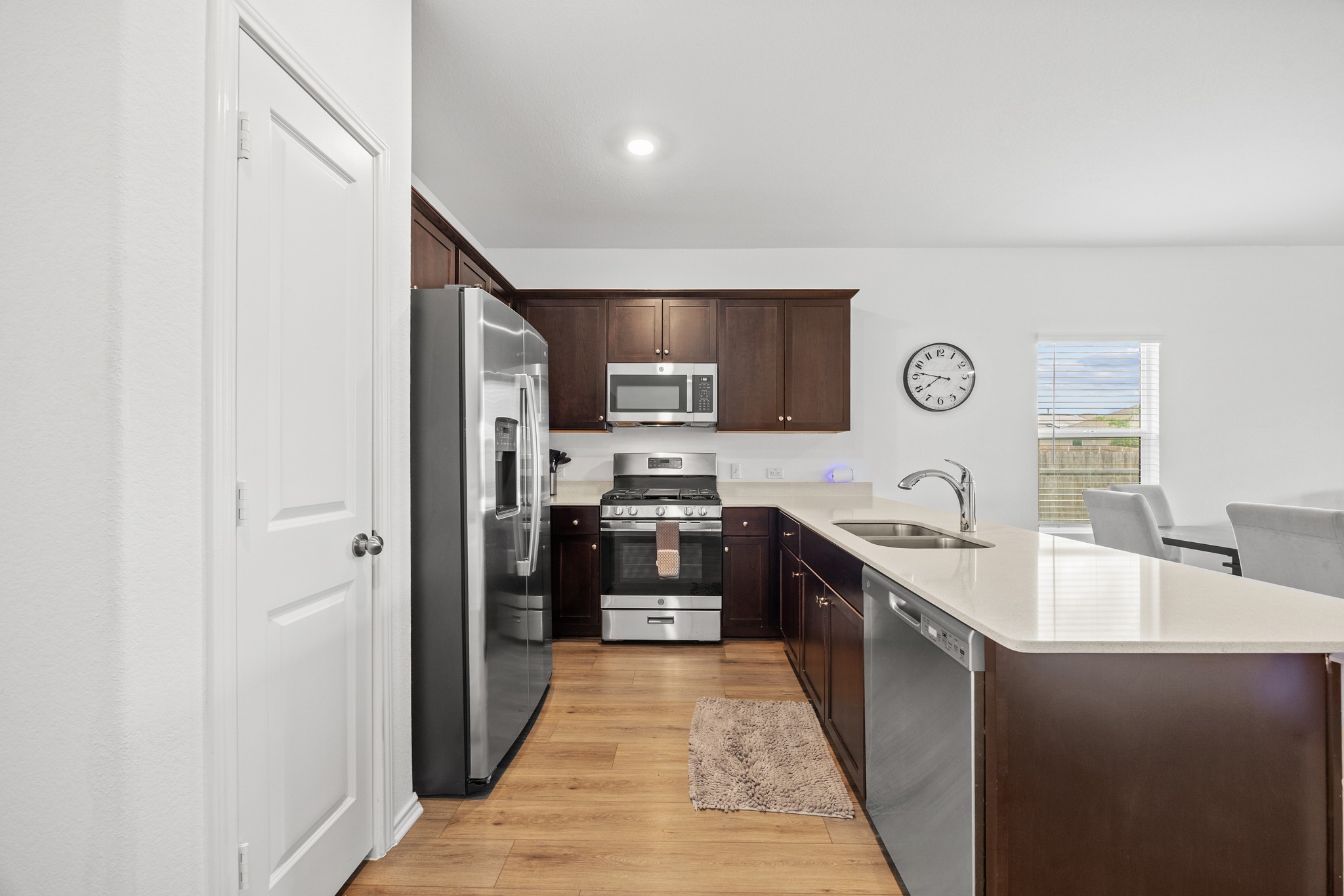 14121 Berning Road Manor, TX 78653 - Photo 5 of 27 A well-appointed kitchen features stainless steel appliances, rich wood cabinetry, and a spacious island.