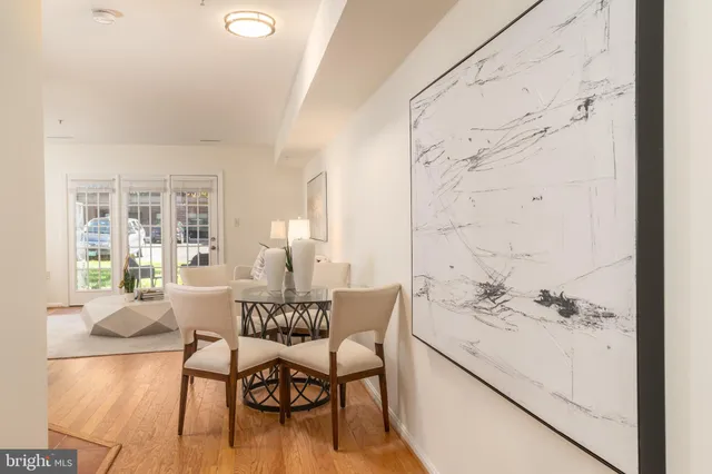 a dining room with furniture and wooden floor