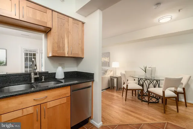 a kitchen with granite countertop a sink and cabinets
