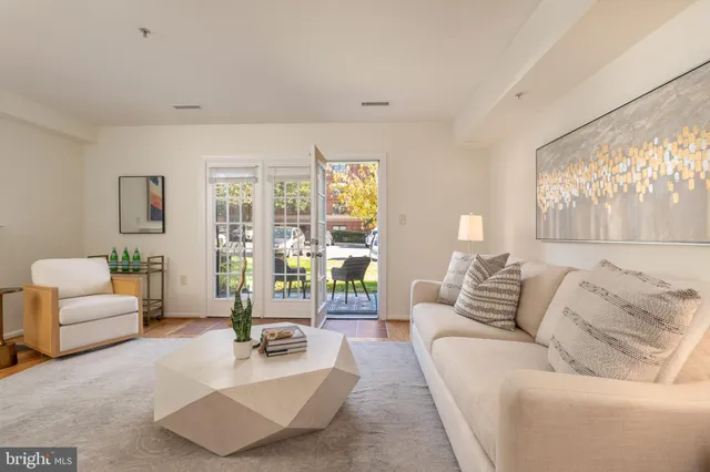 a living room with furniture and floor to ceiling windows