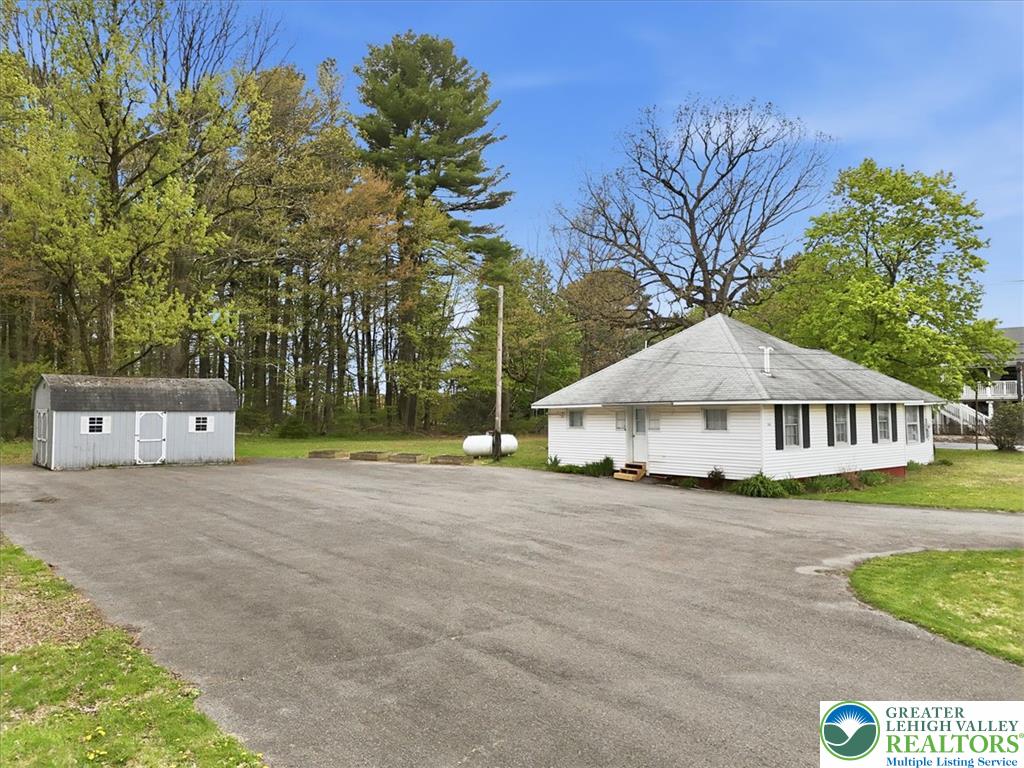 Interchange Road Lehighton, PA 18235 - Photo 10 of 40 A private driveway leads to a charming residence and a practical storage shed, nestled amongst mature trees.
