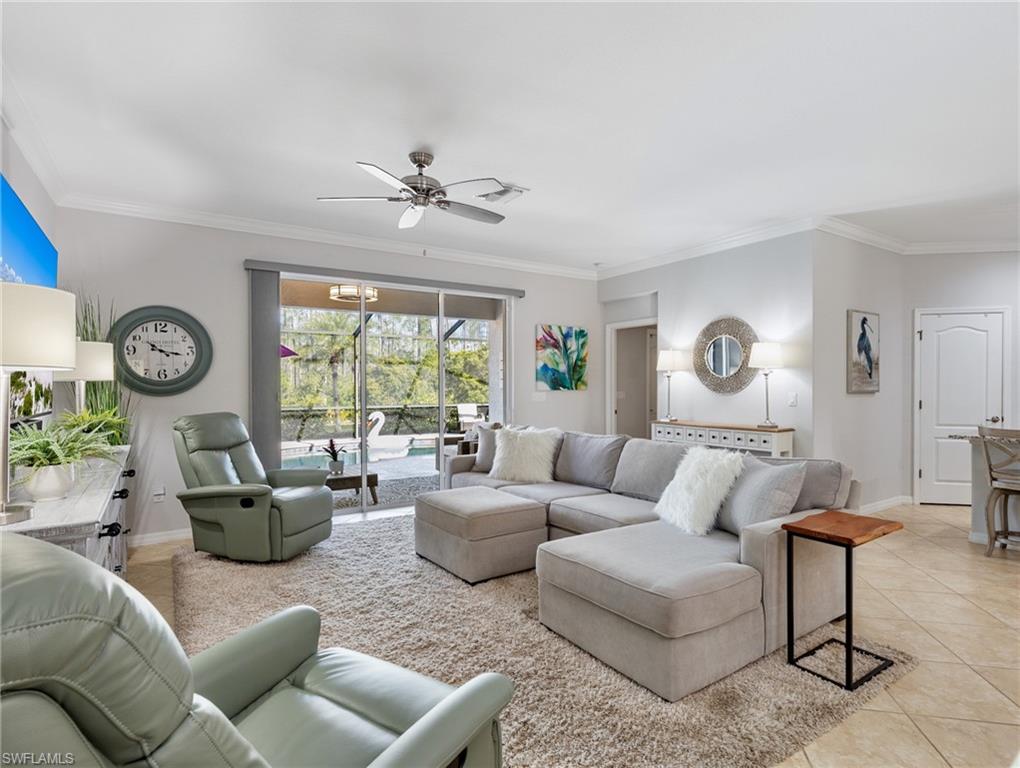 21116 Bella Terra Boulevard Estero, FL 33928 - Photo 11 of 49 a living room with furniture a clock and a large window